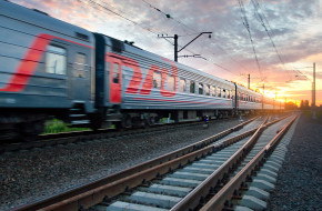 Пассажирский скорый поезд мчится на закате © Александр Тарасенков / Фотобанк Лори